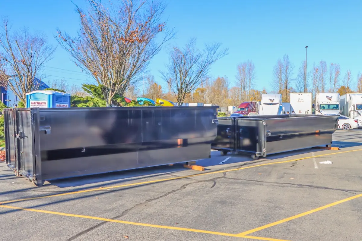 Professional dumpster rental service with roll-off container on residential driveway in Lauderdale-by-the-Sea